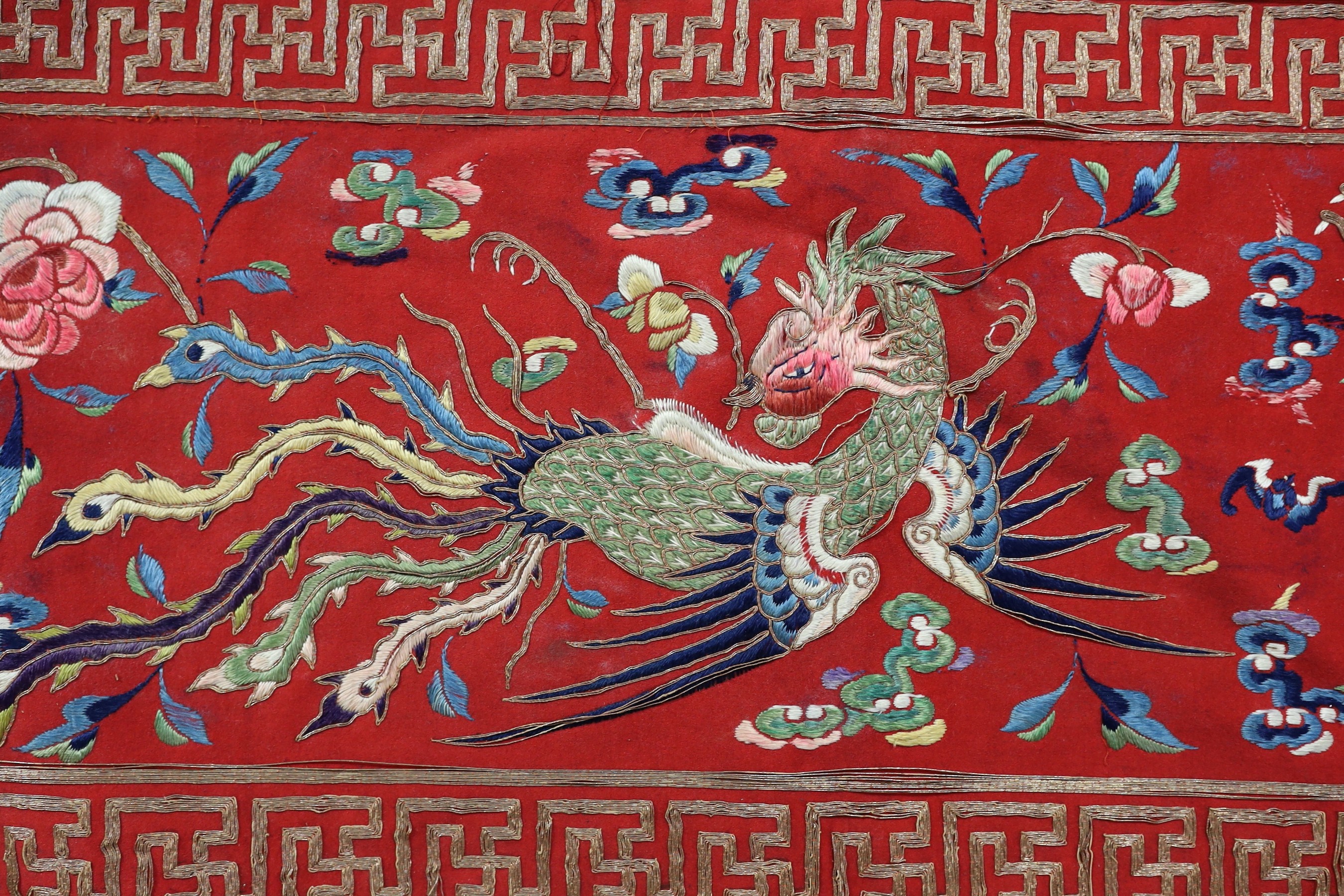 A Chinese embroidered silk ‘dragon, phoenix and lion’ panel or table frontal, late Qing dynasty, 117cm x 337cm